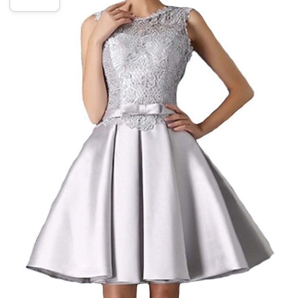 Silver lace cocktail dress with corset back and side pockets.
